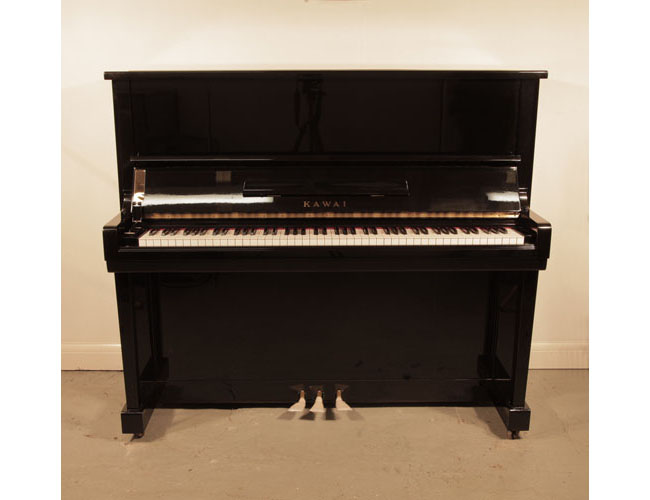 Reconditioned, 1964, Kawai K20 upright piano with a black case and polyester finish. Piano has an eighty-eight note keyboard and three pedals.  