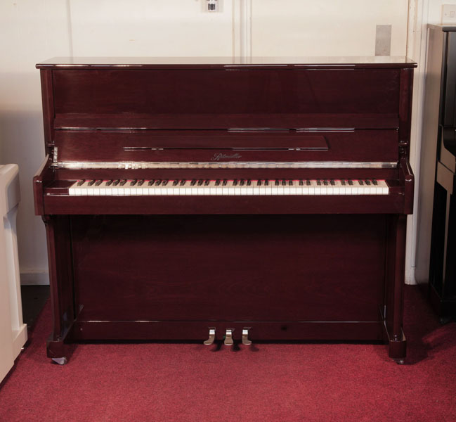 A 2016, Ritmuller EU118S upright piano for sale with a mahogany case and slow fall mechanism. Condition as new. Piano has an eighty-eight note keyboard and and three pedals