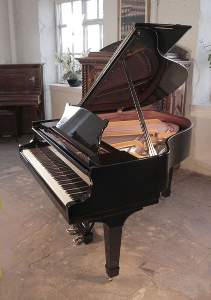 Rebuilt, 1937, Steinway Model S baby grand piano with a black case and spade legs.. Piano has an eighty-eight note keyboard and a two-pedal lyre 
