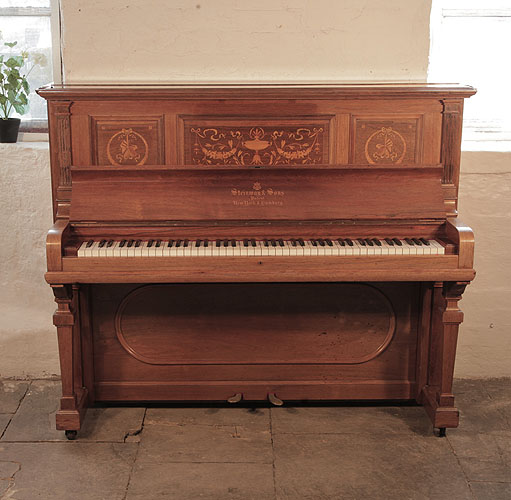 A 1904, Steinway upright piano for sale with a polished, rosewood case and brass fittings. Cabinet features inlaid panels in a Neoclassical design. Piano has an eighty-eight note keyboard and two pedals. 