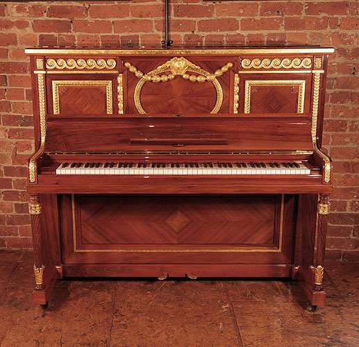 A 1912, Steinway Vertegrand upright piano for sale with a quartered walnut case. Cabinet features carvings of rolling waves, strapwork and beading highlighted with gold. Piano was commissioned for the RMS Olympic Liner, sister to the Titanic. Piano has an eighty-eight note keyboard and two pedals.