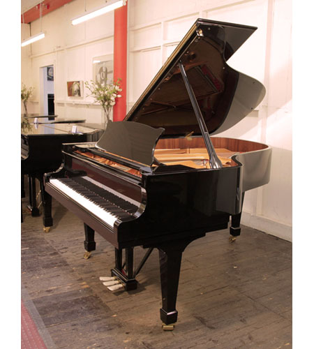 A 2018, Toyama TC-187 grand piano for sale with a black case and brass fittings. Piano has an eighty-eight note keyboard and a three-pedal lyre. 