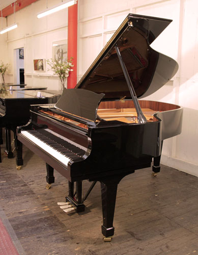 Brand new, Toyama TC-187 grand piano for sale with a black case and spade legs. Piano has an eighty-eight note keyboard and a three-pedal lyre.