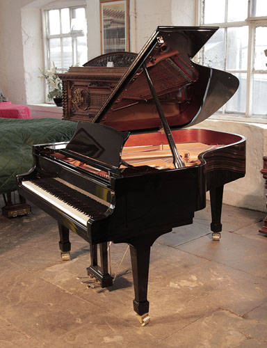 Toyama TC-187 grand piano for sale with a black case and spade legs. Piano has an eighty-eight note keyboard and a three-pedal lyre.