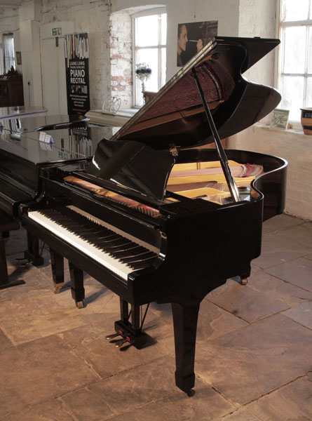 Reconditioned, 1975, Yamaha G2 grand piano for sale with a black case and spade legs. Piano has an eighty-eight note keyboard and a two-pedal lyre. 