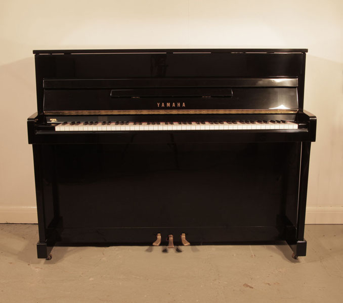 Reconditioned, 1972, Yamaha LX-110 upright piano for sale with a black case and brass fittings. Piano has an eighty-eight note keyboard and three pedals.  