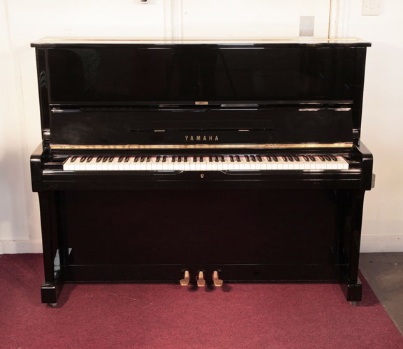  Reconditioned, 1974, Yamaha U1 upright piano with a black case and polyester finish. Piano has an eighty-eight note keyboard and three pedals. 
