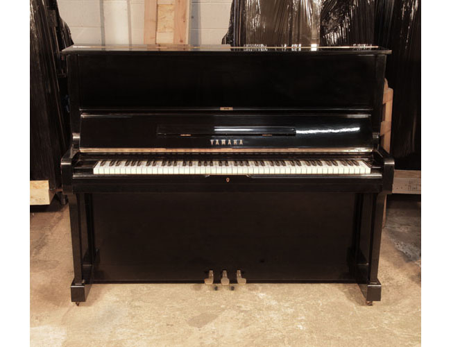 Reconditioned, 1973, Yamaha U1 upright piano with a black case and polyester finish. Piano has an eighty-eight note keyboard and three pedals.
