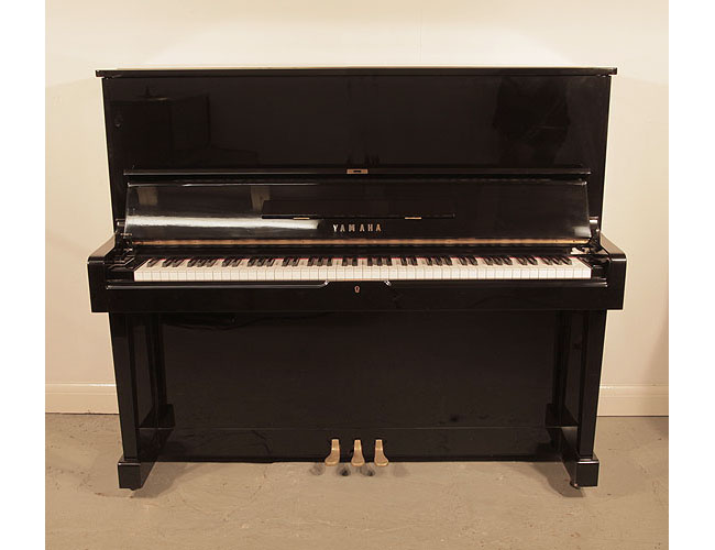 Reconditioned, 1965, Yamaha U2 upright piano with a black case and polyester finish. Piano has an eighty-eight note keyboard and three pedals.
