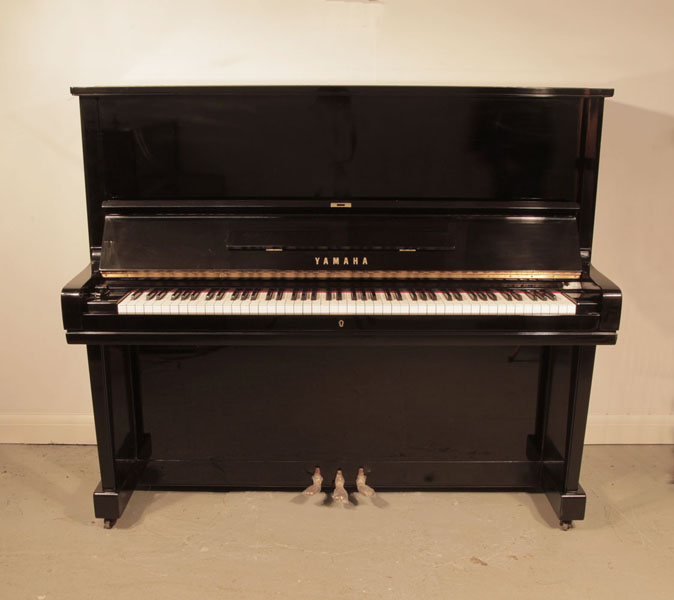 Pre-owned, 1968, Yamaha U3 upright piano for sale with a black case and brass fittings. Piano has an eighty-eight note keyboard and three pedals. 