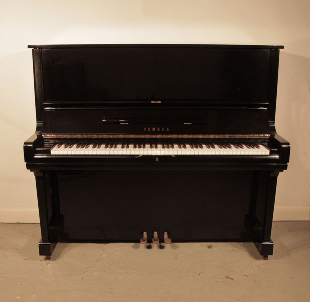 Reconditioned, 1976, Yamaha U3 upright piano for sale with a black case and brass fittings. Piano has an eighty-eight note keyboard and three pedals. 