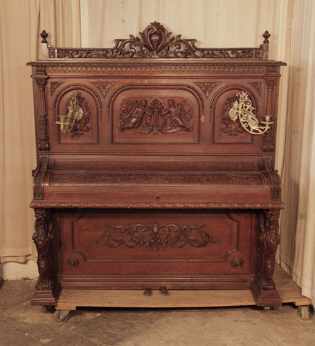 Neoclassical style, Francke upright piano for sale with an ornately carved, oak case and griffin legs. Cabinet features carved angels, lions heads, acanthus and openwork arcading.Piano has an eighty-five keyboard and two pedals. 