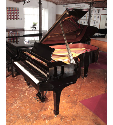 Reconditioned,  2008, Steinway Model B grand piano for sale with a black case and spade legs. Piano has an eighty-eight note keyboard and a three-pedal lyre. 