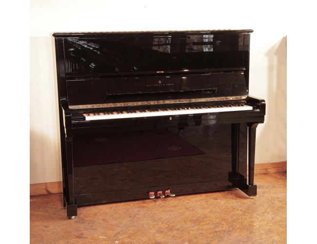 Reconditioned, 1990, Steinway Model K upright piano for sale with a black case and brass fittings. Piano has an eighty-eight note keyboard and three pedals.  Piano features a third sostenuto pedal.  