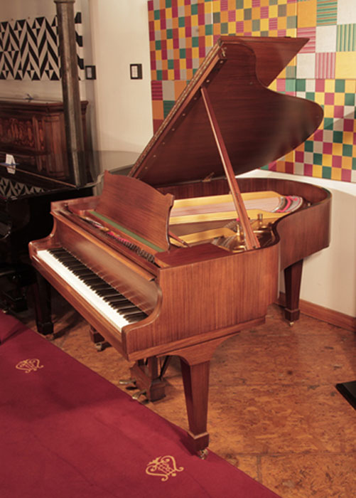 Restored,  1961, Steinway Model M grand piano with a satin, walnut case and spade legs. Piano has an eighty-eight note keyboard and a two-pedal lyre.