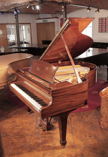 Rebuilt, 1937, Steinway Model S baby grand piano with a crown cut mahogany case and spade legs. Piano has an eighty-eight note keyboard and a two-pedal lyre. 
