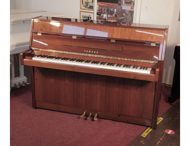 Reconditioned, 1987, Yamaha M108 Upright piano for sale with a walnut gloss case and brass fittings. Piano has an eighty-eight note keyboard and three pedals.   