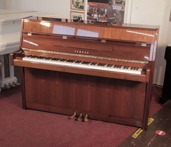  Reconditioned, 1987, Yamaha M108 Upright piano for sale with a walnut gloss case and brass fittings. Piano has an eighty-eight note keyboard and three pedals.