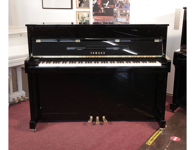 Pre-owned, 2022, Yamaha b2e PE upright piano with a gloss black case and brass fittings. Condition as new.  Piano has an eighty-eight note keyboard and three pedals.   
