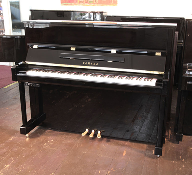  A 2020,  Yamaha b3e PE-Silent upright piano with a black case and fitted Silent System. Piano has an eighty-eight note keyboard and three pedals.