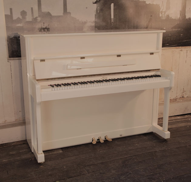 Reconditioned 2008, May upright piano in ivory gloss with brass fittings.  Piano has an eighty-eight note keyboard and three pedals 