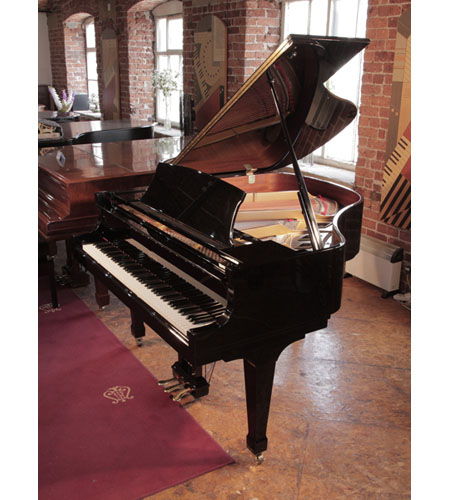 Reconditioned 2000, Boston GP156 II baby grand piano with a black case and spade legs. Designed by Steinway. Piano has an eighty-eight note keyboard and a three-pedal lyre. 