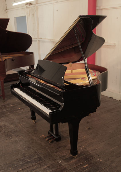 Reconditioned, 2006, Boston GP156 baby grand piano for sale with a black case and spade legs. Piano has an eighty-eight note keyboard and a three-pedal lyre.
