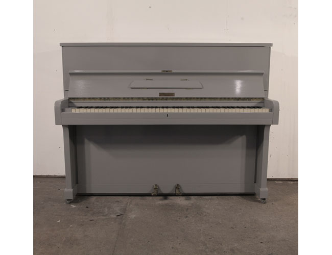 A 1953, Broadwood upright piano with a grey gloss cabinet and brass fittings