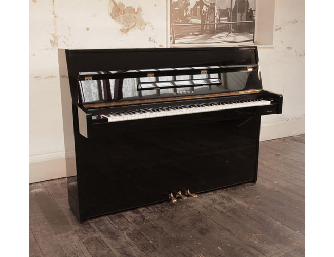 A 1997, Eterna ER-C10 upright piano for sale in black gloss. Piano has an eighty-eight note keyboard and three pedals.