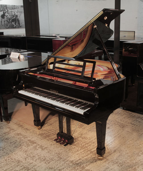 Reconditioned 2015,  Feurich Model 161 Professional baby grand piano with a black case and brass fittings.  Piano has an eighty-eight note keyboard and a three-pedal piano lyre. 
