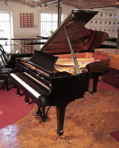  A 2006,  Steinway Model B grand piano for sale with a black gloss case and spade legs. Piano has a three-pedal lyre and an eighty-eight note keyboard. 