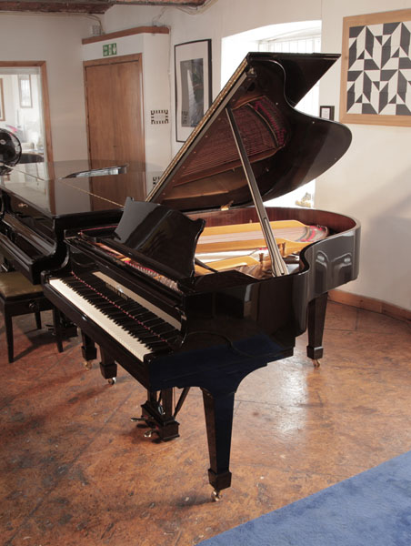 Restored 1961, Steinway Model M grand piano in black gloss case and spade legs. Piano has an eighty-eight note keyboard and a two-pedal lyre 