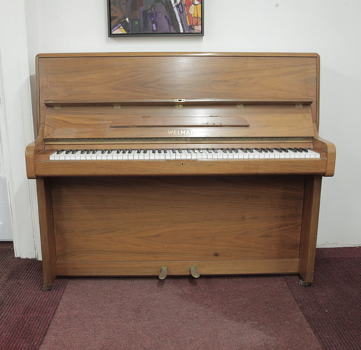 A 1981, Welmar upright piano with a walnut case and Schwander action. Piano has an eighty-eight note keyboard and two pedals.