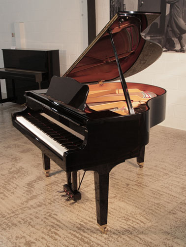 Reconditioned, 2005, Yamaha GB1 baby grand piano for sale with a black, gloss case and square, tapered legs. Piano has an eighty-eight note keyboard and a three-pedal lyre. 