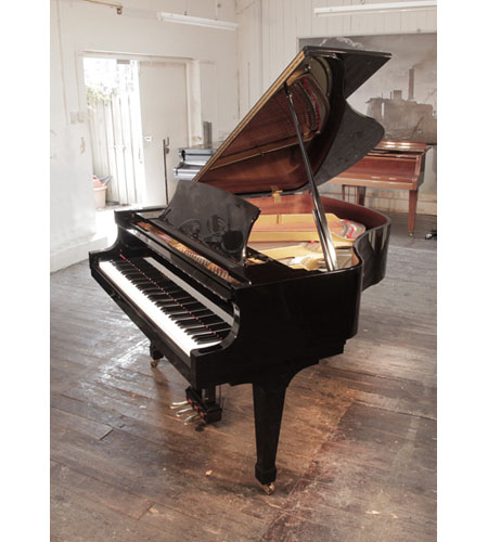 Reconditioned 1999, Boston GP156 II baby grand piano with a black gloss case and brass fittings. Piano has an eighty-eight note keyboard and a three-pedal lyre. 