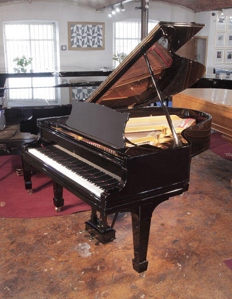 Rebuilt 1922, Steinway Model O grand piano with a black case and spade legs. Piano has an eighty-eight note keyboard and a two-pedal lyre.